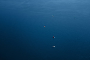 Fototapeta na wymiar Blue sea surface with yachts. Landscape. Classic Blue color 2020.