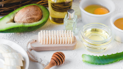 Composition with natural ingredients for facial or hair mask. Avocado with olive oil, egg and honey. Homemade beauty products and zero waste concept