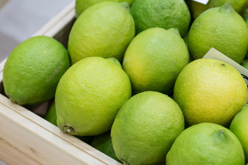Fresh ripe green limes on wooden box