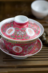 A chinese gaiwan with tea on a tea table