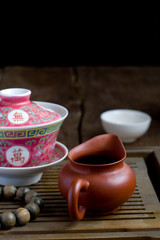 A chinese gaiwan with tea on a tea table