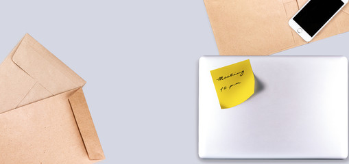 Office desk with closed notebook with yellow post-it for meeting. - 307949365