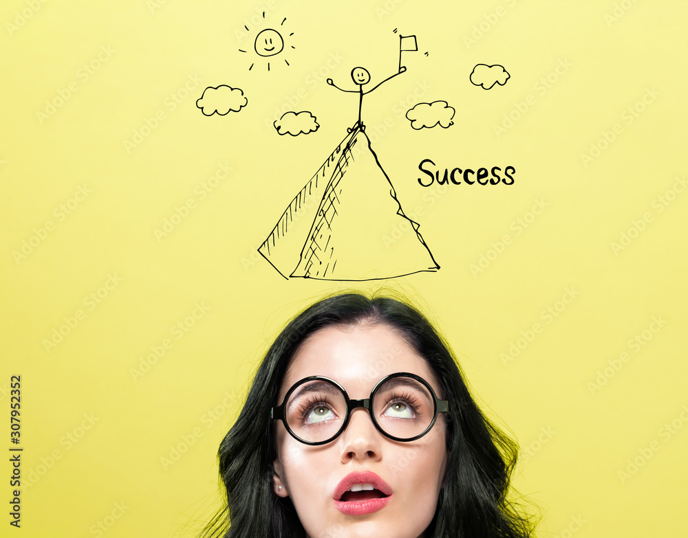 Poster standing on the top of a mountain with young woman wearing eye glasses