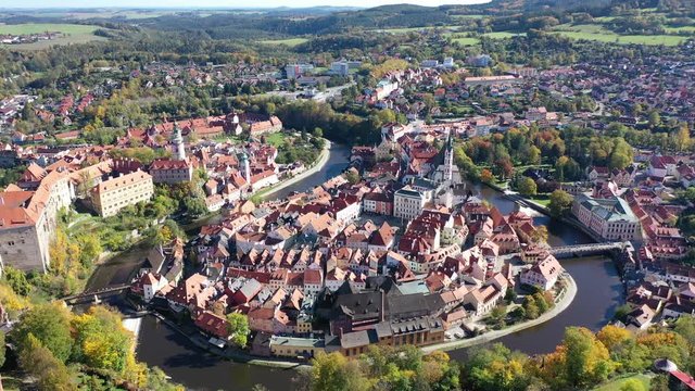 Aerial view of historical centre of Cesky Krumlov town on Vltava riverbank on autumn day overlooking medieval Castle, Czech Republic