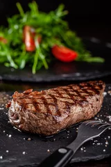  Farm organic food concept. Grilled beef steak with grill. Fried steak on on black slate, on a black background. © zukamilov