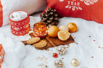 Christmas cozy mood still life. Tangerine and cookies, candle over white background