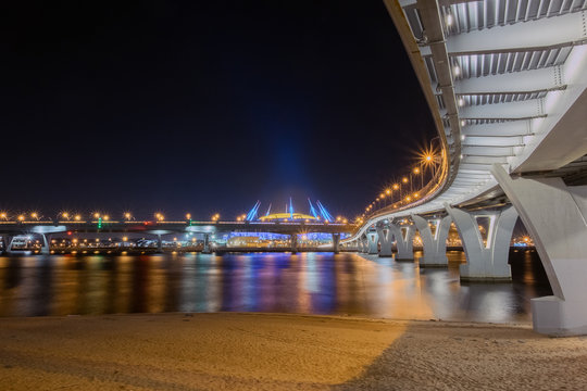 The new Zenit arena stadium, where the 2018 FIFA world Cup was held. Night view from under the pedestrian bridge intertwined with the bridges of the ZSD highway
