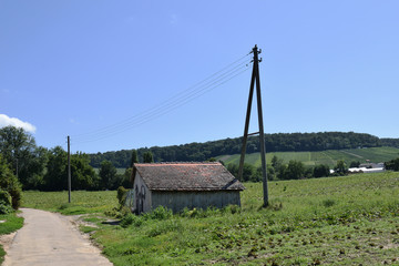 Fototapeta na wymiar Old Wooden Barn in Empty Field with Telegraph Poles 6522-042
