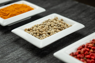White pepper. Colorful spices in white bowls Seasonings for cooking. Natural Herbs & Spices.