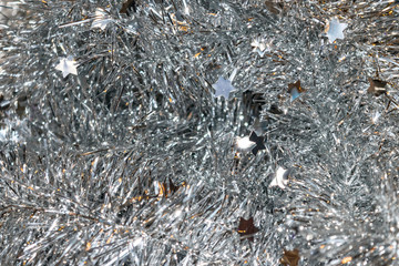 Christmas shiny glitter background with silver tinsel macro texture.	