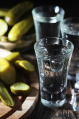 Three shots with vodka and pickled cucumbers