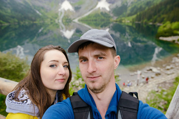 Happpy couple taking selfie withe lake background