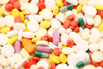 Different colorful tablets at white background	