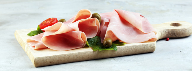 Sliced ham on wooden background. Fresh prosciutto cotto. Tasty Pork ham sliced