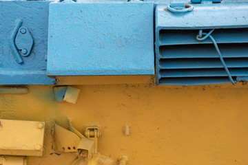 Close up of metal machine in the colors of flag of Ukraine, selective focus. 
