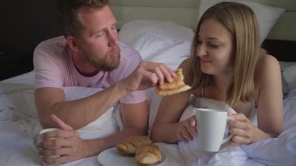 Family having breakfast in bed - Powered by Adobe