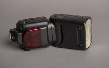 Camera off flash on the gray background. Photography equipment.