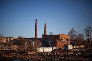 Brick factory of the old architectural style. Boiler pipes.