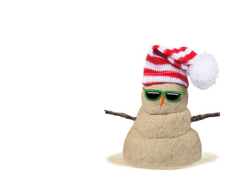 Christmas sandy snowman in sand with red and white striped hat isolated on white
