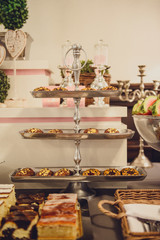 Delicious sweets on candy buffet. Wedding bakes on trays