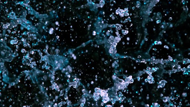 Super Slow Motion Abstract Shot of Splashing Blue Neon Water at 1000fps. Filmed with High Speed Cinema Camera in 4K Resolution.