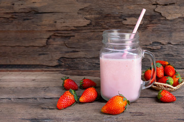 Strawberry yogurt fruit juice smoothie pink colorful fruit juice milkshake blend beverage healthy high protein the taste yummy In glass drink episode morning on wood background.