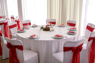 a beautiful restaurant table decorated with red ribbons, Chinese New Year, table number six, in anticipation of a banquet