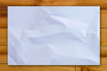 white paper on wood table background.