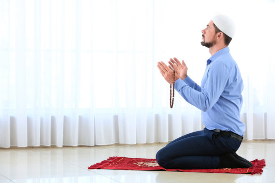 Muslim man praying in room