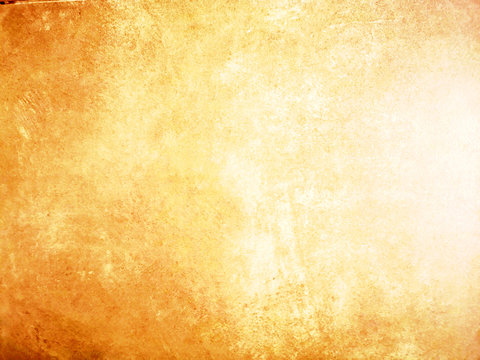 The distribution of light and abstract background yellow tone color on old cement wall
