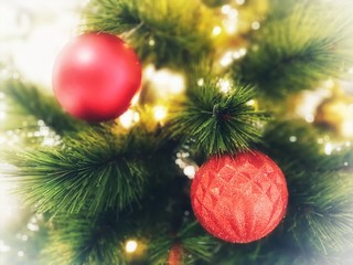 Christmas tree decorated with beautiful ornaments and lighting. garland background and xmas wallpaper.