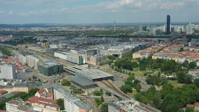 sunny day flight over vienna city train station traffic district aerial panorama 4k austria