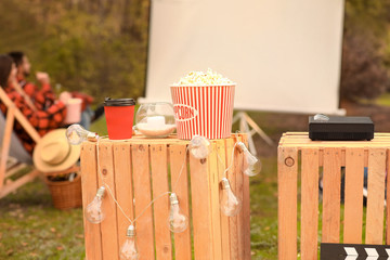 Multimedia DVD projector with popcorn in outdoor cinema