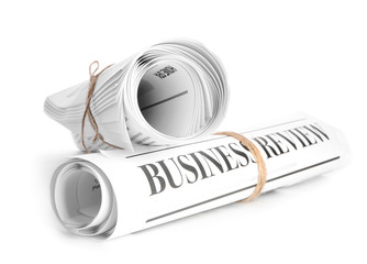 Morning newspapers on table against white background