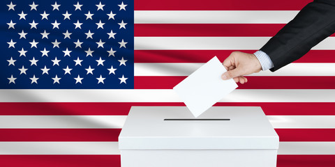 Election in United States. The hand of man putting his vote in the ballot box. Waved United States flag on background.