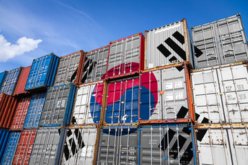 The national flag of South Korea on a large number of metal containers for storing goods stacked in rows on top of each other. Conception of storage of goods by importers, exporters
