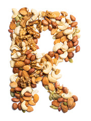 Letter R of the English alphabet from a mixture of hazelnuts, almonds, walnuts, peanuts, cashews, pumpkin seeds on a white isolated background. Food pattern made from nuts. Bright alphabet for shops.