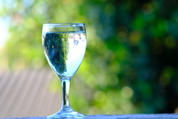 glasses of  water on green background
