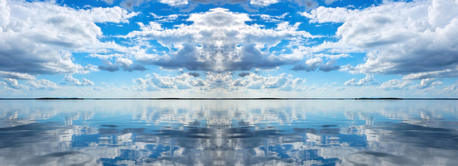 Atmospheric sky art seascape. White Cumulus cloud in blue sky over ocean. Australia.