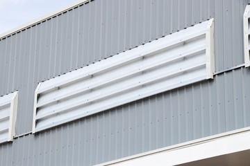 Metal sheet roof and wall steel with louver build factory and warehouse with blue sky. close up texture