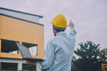 Project Engineering construction use computer notebook working on site management