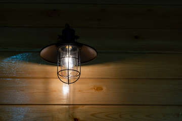 Vintage wall lamp on wooden wall texture interior lighting bulbs decoration contemporary