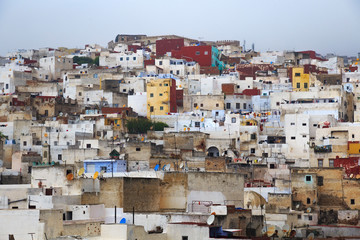View of the colorful old buildings of Tetouan Medina quarter in Northern Morocco. A medina is typically walled, with many narrow and maze-like streets and often contain historical houses and places.