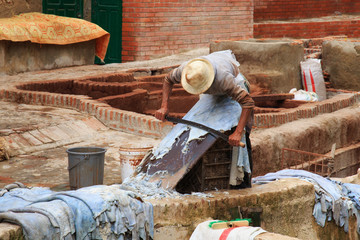 Courtyard with different stone vats with dye for leather in Tannery of Tetouan Medina. Northern Morocco.