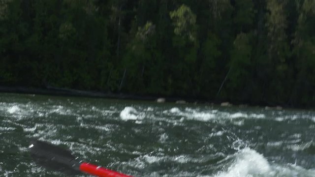 Handheld shot inside a raft as it travelling down river rapids.