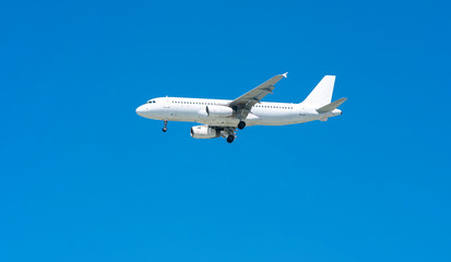 Fototapeta na wymiar Airplane through blue sky prepare to landing