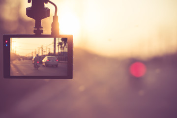 Burred photos,Close up car on highway at sunset, with video recorder next to a rear view...
