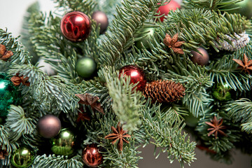 Closeup details of Beautiful Christmas wreath of fresh spruce on the white door. Entrance to the house. Christmas mood. Xmas tree.