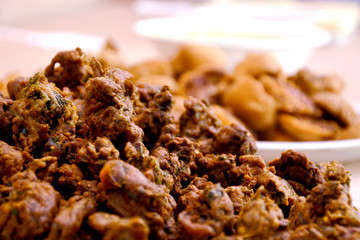 Crispy onion bhajis or kanda or pyaj ke pakore or pakoda , delicisous indian and brazilian street food on salad, typically enjoyed in rainy / monsoon season with hot tea, selective focus