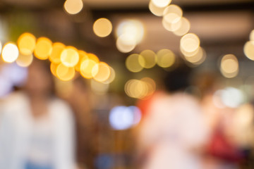 beautiful abstract blurred bokeh of orange lights indoor shop background.